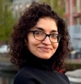 A person with curly hair wearing glasses

AI-generated content may be incorrect.