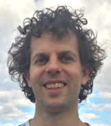 A person with curly hair smiling

AI-generated content may be incorrect.